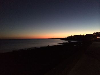 Scenic view of sea against clear sky at sunset