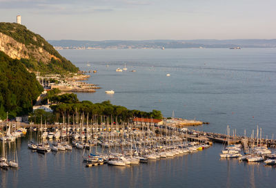 Sailboats moored in harbor