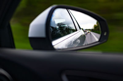 Reflection of car on side-view mirror