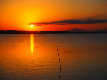 Scenic view of sea against romantic sky at sunset