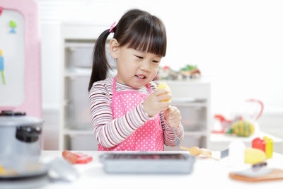 Young girl pretend play food preparing at home