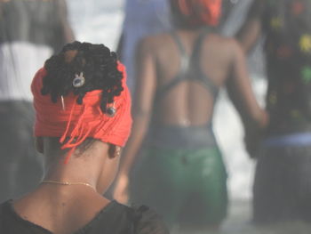 Rear view of woman standing against blurred background