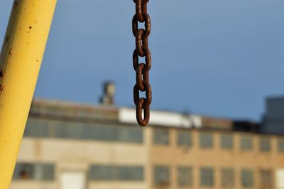 Low angle view of chain against building