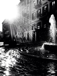 Sun shining through buildings in city