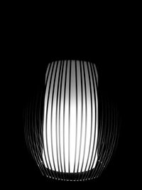 Close-up of illuminated lamp against black background