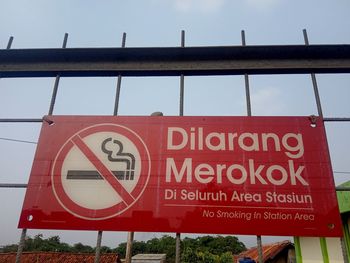 Low angle view of road sign against sky