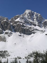 Scenic view of snowcapped mountains against clear sky