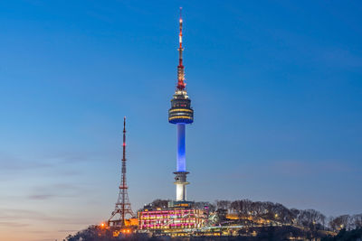 Low angle view of illuminated building against blue sky