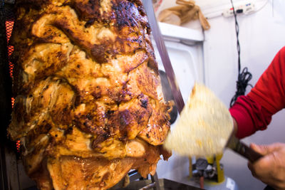 Close-up of cutting chiken meat of kebab