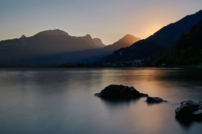 Scenic view of mountains against sky at sunset