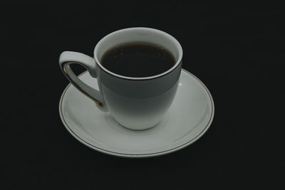 Coffee cup against black background