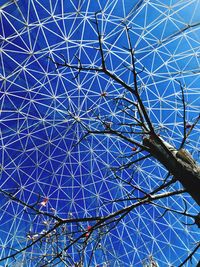 Low angle view of ferris wheel against blue sky