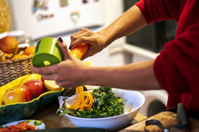 Latin woman cooking a salad for her diet