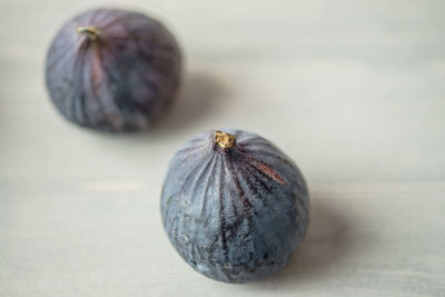 Close-up of figs on white table