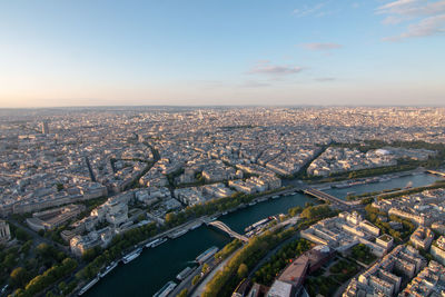 High angle view of river amidst buildings in city against sky