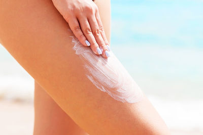 Close-up of woman hand on beach