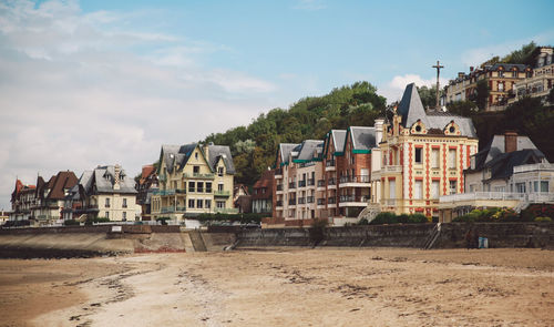 Houses in city against sky