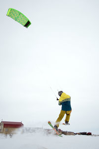 Man with umbrella on snow