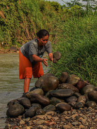 Portrait of man sitting on rock