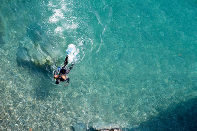 High angle view of man swimming in sea