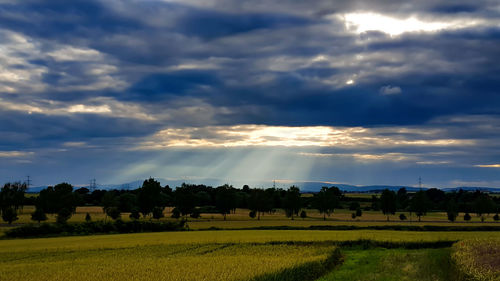 Idyllic shot of rural landscape against cloudy sky