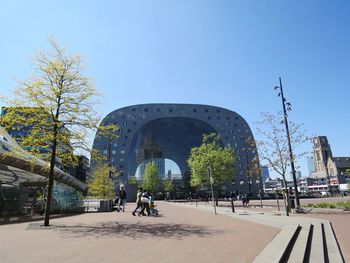 People on street in city against clear sky