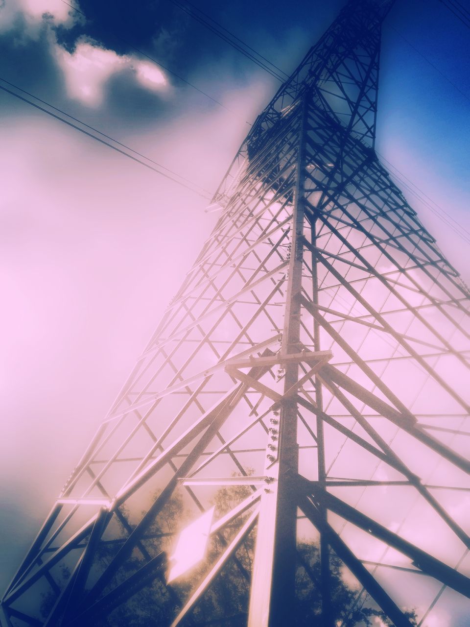 low angle view, built structure, architecture, sky, building exterior, connection, cloud - sky, modern, cloud, power line, tall - high, electricity pylon, cable, electricity, no people, city, outdoors, technology, office building, day