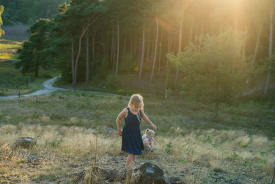 Sisters playing on grassy field