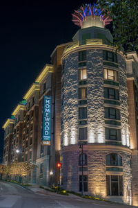 Low angle view of illuminated building against sky at night