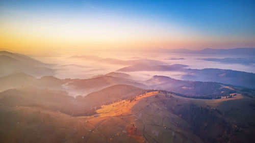 Scenic view of mountains against sky during sunset