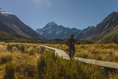 Man standing on mountain against sky