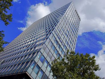 Low angle view of modern building against cloudy sky