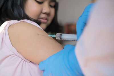 Girl taking vaccination on arm