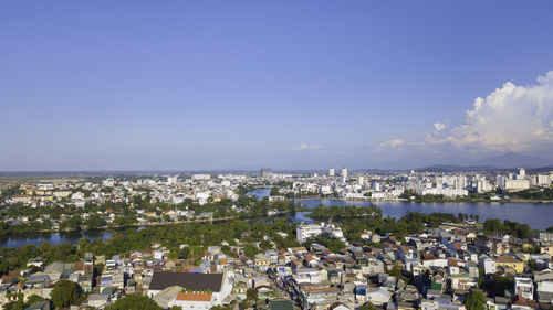 High angle view of townscape by sea against sky