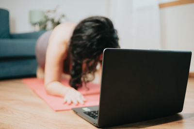 Woman using laptop at table