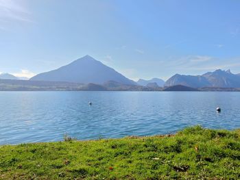 Scenic view of lake and mountains against sky