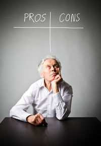 Portrait of a man sitting on table