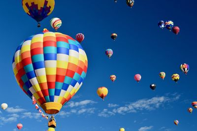 Low angle view of colorful hot air balloons against sky