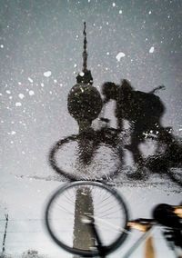 Shadow of man on bicycle in winter