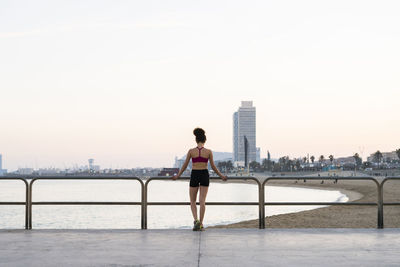 Spain, barcelona, back view of young jogger