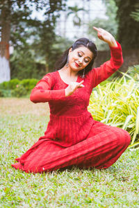 Young woman sitting on field