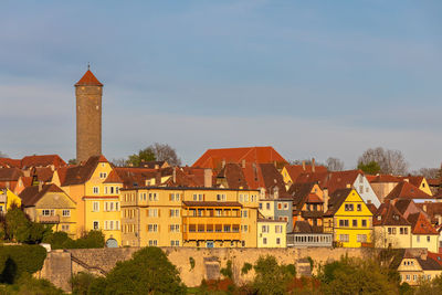 Buildings in town against sky