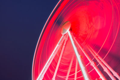 Low angle view of illuminated ferris wheel against sky at night