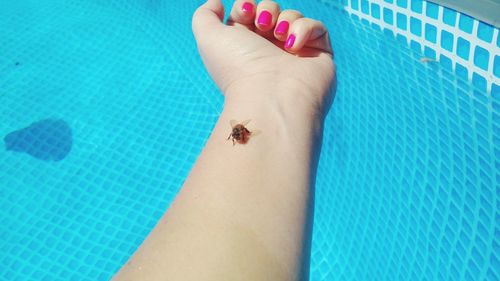 Low section of human feet on swimming pool