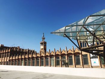 Low angle view of buildings against blue sky