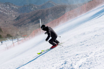 Man skiing on mountain during winter