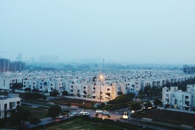 High angle view of buildings in city against clear sky