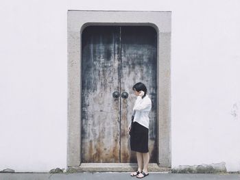 Full length of woman standing on wall