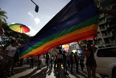 People on multi colored umbrellas against sky