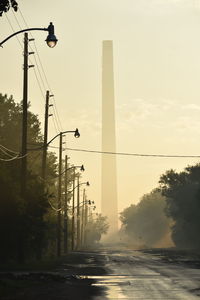 Street lights against sky during sunset